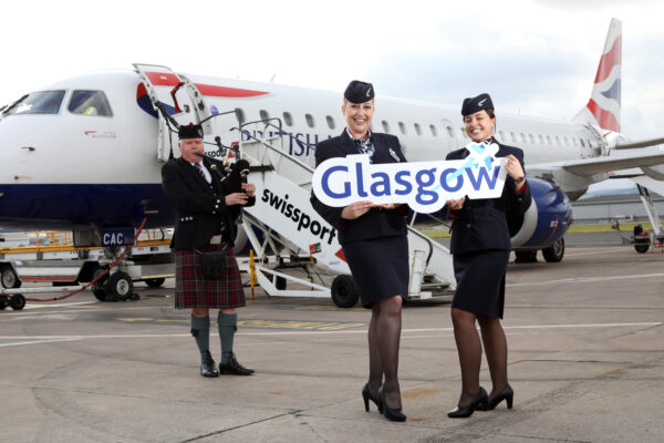 Flights to Glasgow have commenced from Belfast City Airport. Pictured with a bagpiper to mark the occasion are British Airways cabin crew Lucienne McCarthy and Laura Richardson 1